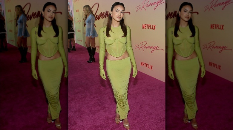 Camila Mendes on the red carpet in a green top and skirt 