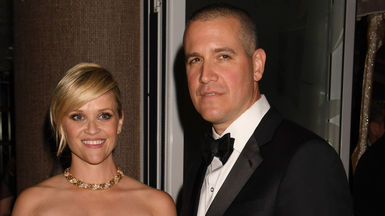 Reese Witherspoon smiling beside Jim Toth