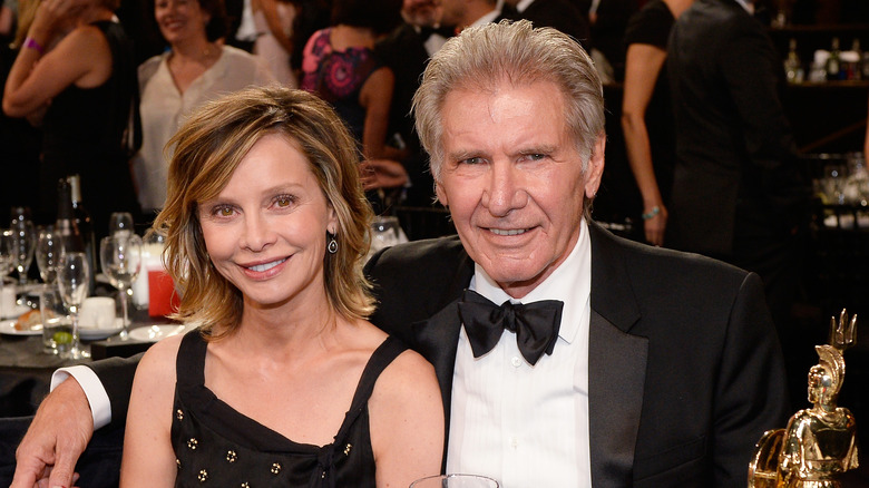 Calista Flockhart and Harrison Ford arm in arm at an awards show