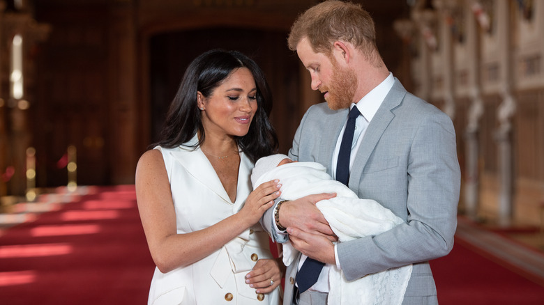 Prince Harry and Meghan Markle holding Prince Archie