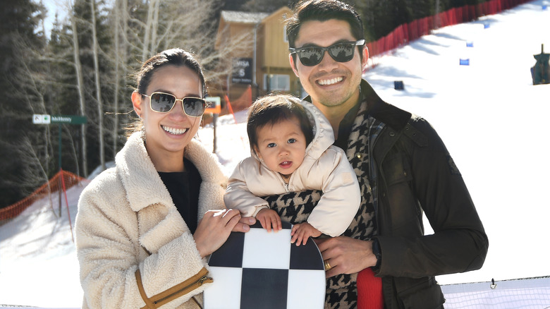 Henry Golding and wife with daughter in snow