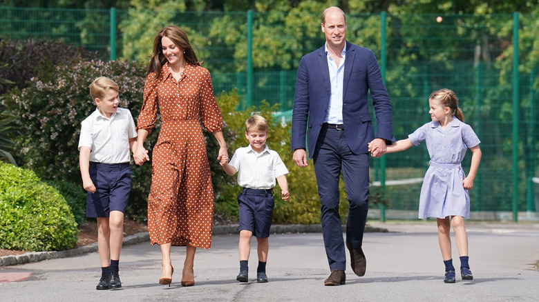 Prince and Princess of Wales walking with their kids