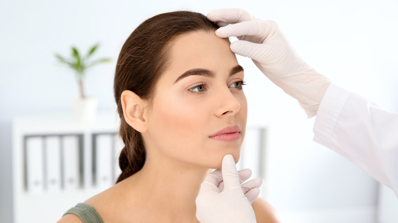 doctor examining patient's skin