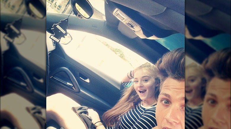 Sophie Turner and James McVey posing in the car