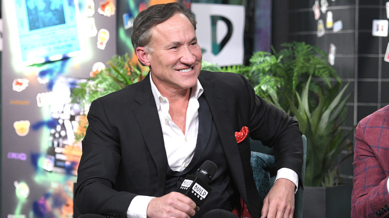 Terry Dubrow smiling in a black suit