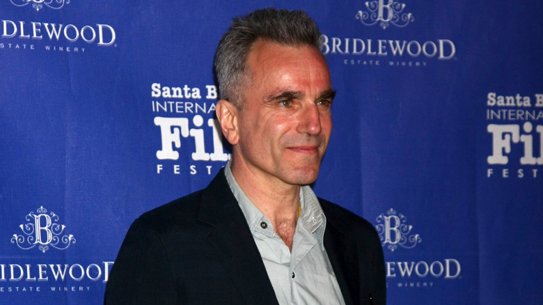 Daniel Day-Lewis gives a small smile