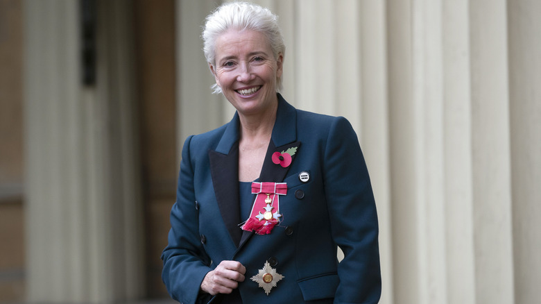 Emma Thompson smiles and poses for a photo after receiving her damehood 