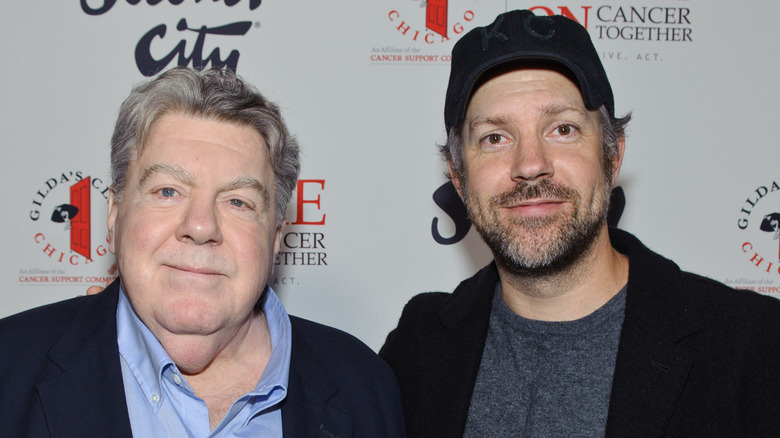 George Wendt and Jason Sudeikis smirking 