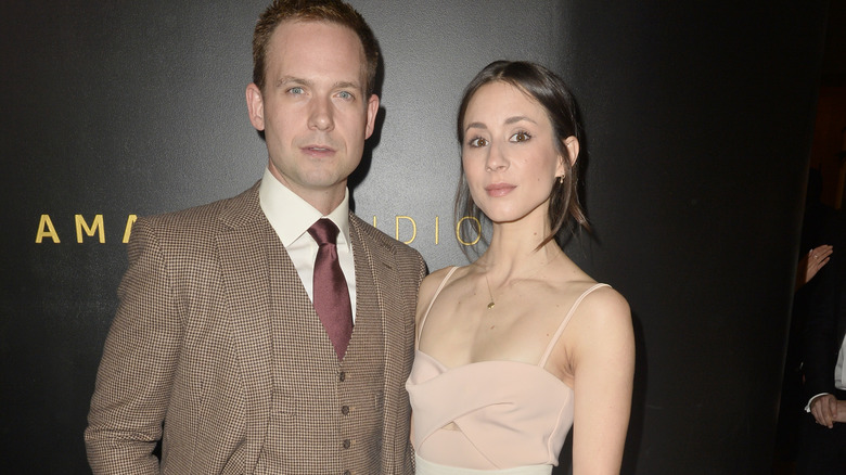 Troian Bellisario and Patrick J. Adams posing