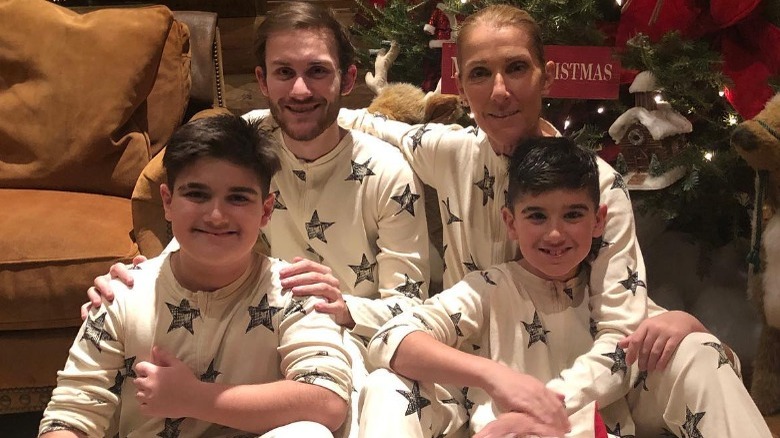 Dion family sitting under Christmas tree