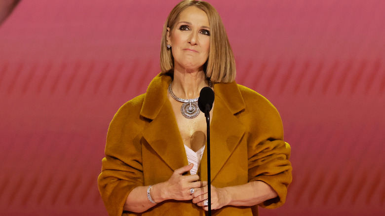 Celine Dion looking up, standing at microphone