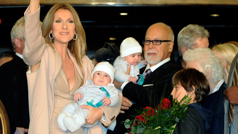 Céline Dion and René Angélil holding Eddy and Nelson Angélil