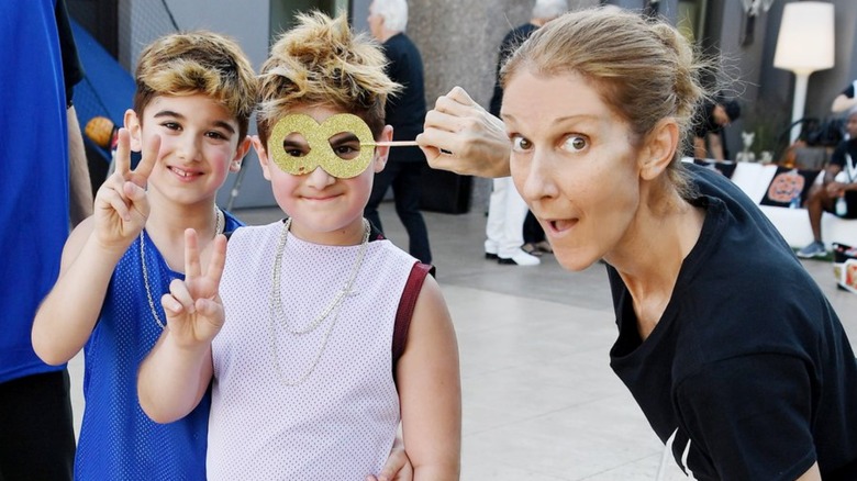 Céline Dion, Eddy, and Nelson Angélil smiling