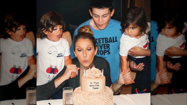 Eddy, Nelson, and René-Charles Angélil watching Céline Dion blow out a candle