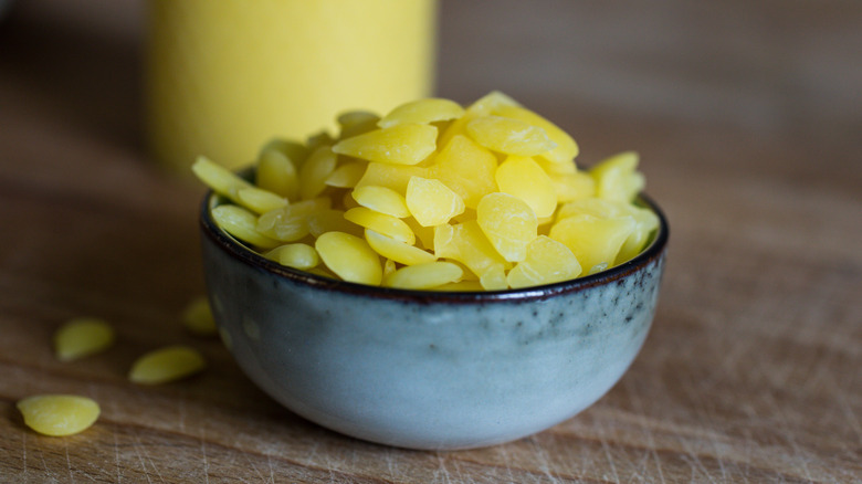 Bowl of yellow wax beads