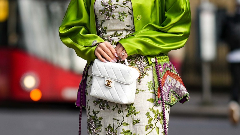 Woman holding white Chanel bag