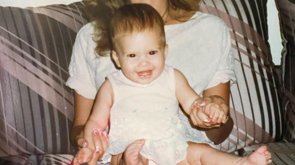 Chanel West Coast as a baby on her mother's lap