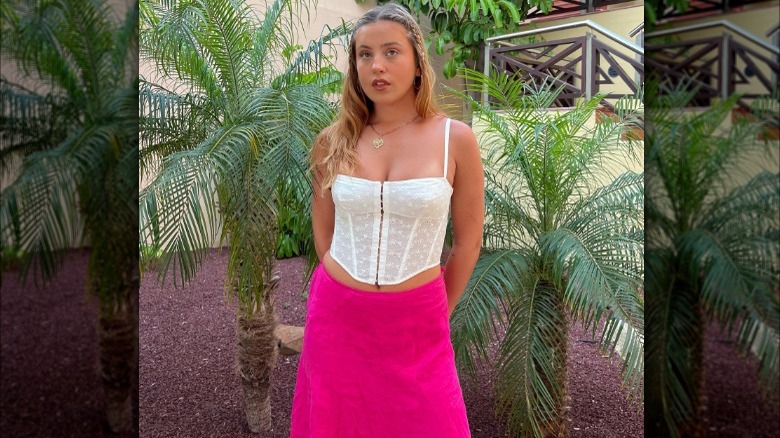 woman in corset beside palm trees