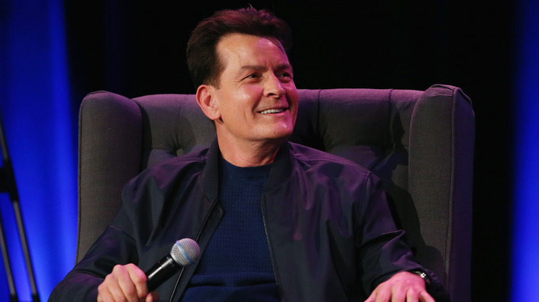 Charlie Sheen grins onstage during interview
