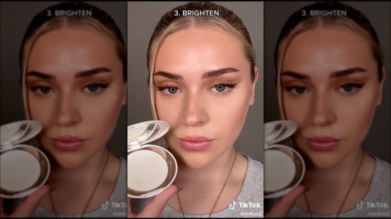 Woman holding powder makeup