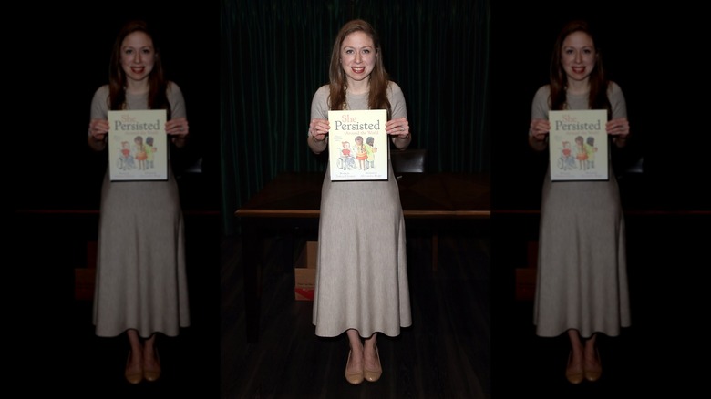 Chelsea Clinton smiling with her book