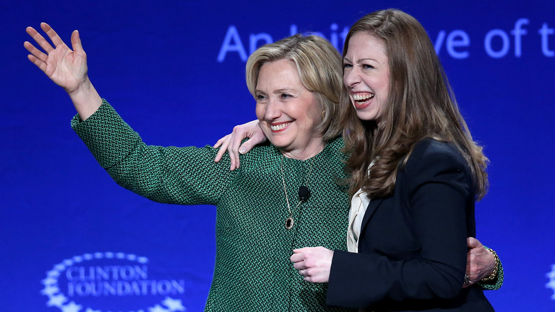 Chelsea and Hillary Clinton embracing onstage