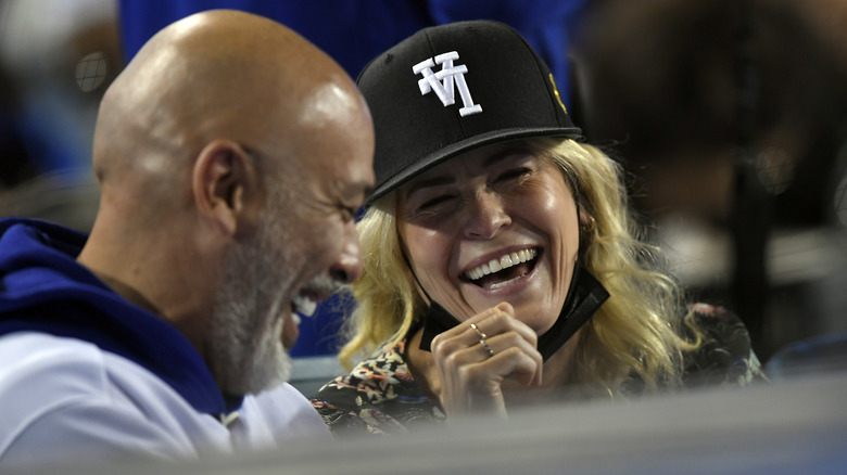 Chelsea Handler and Jo Koy laughing at baseball game