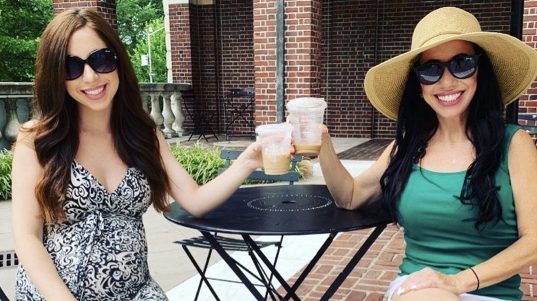 Cher and Dawn Hubsher smiling and drinking