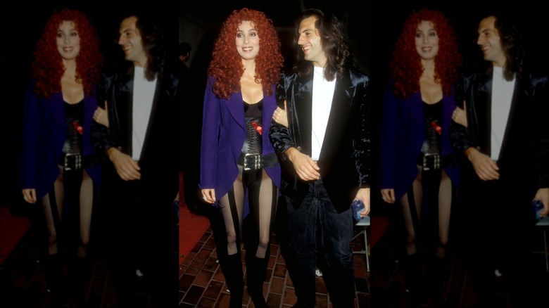 Cher posing in purple jacket with red curly hair