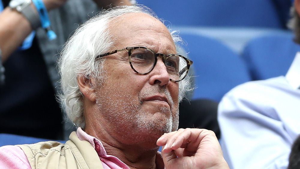 Chevy Chase watching a tennis match