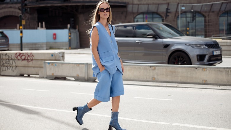 A woman in blue tailored outfit