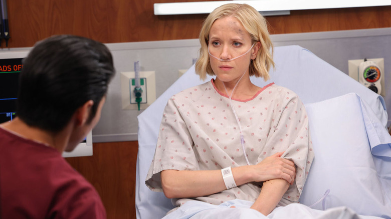 Jessy Schram sitting in bed in Chicago Med