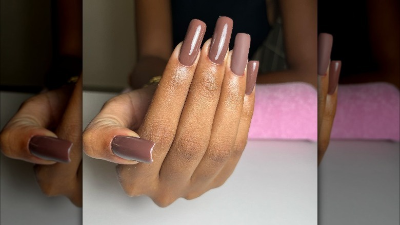 Rich brown nails with one matte finger