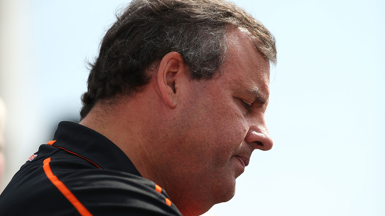 Profile of Chris Christie pensive and outdoors