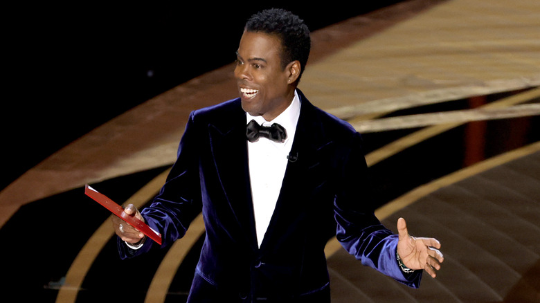 Chris Rock standing on stage at the Academy Awards