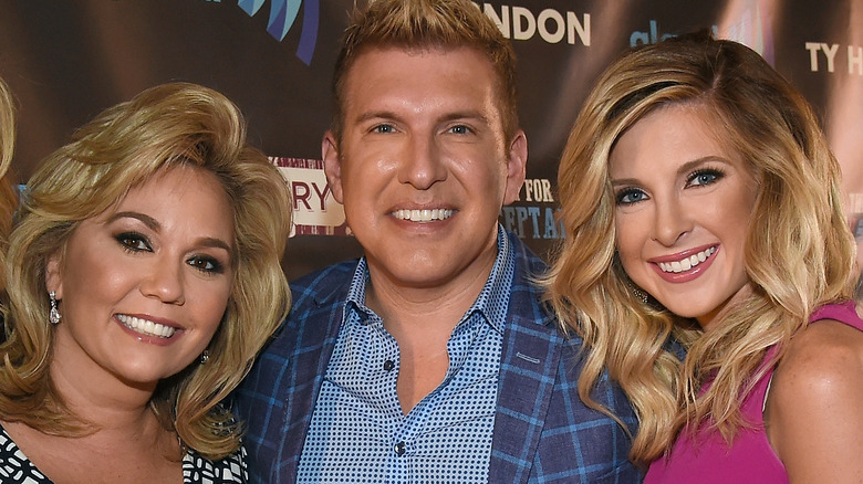 Lindsie Chrisley smiles opposite parents Todd and Julie Chrisley