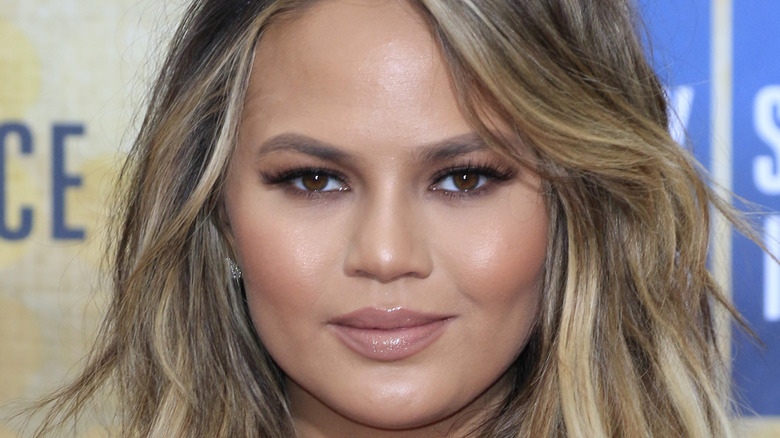 Chrissy Teigen poses on the red carpet