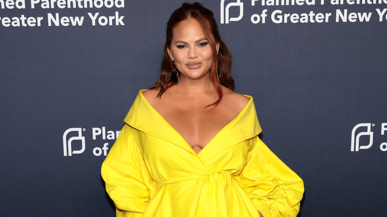 Chrissy Teigen wearing yellow