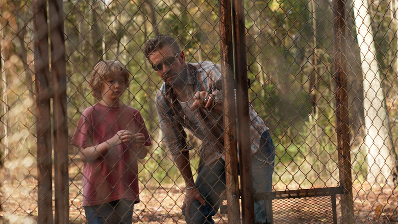 Rob Horton and Beauchamp standing outside a fence