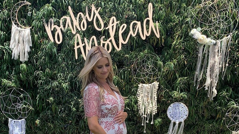 Christina Anstead posing with her baby