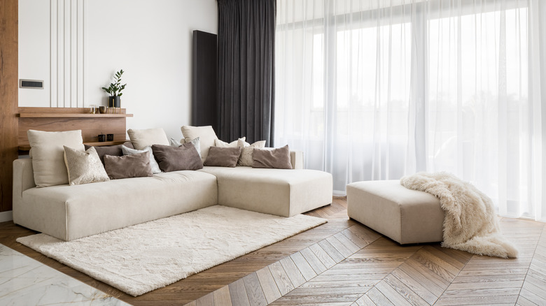 Modern living room with chevron patterned wood floors 