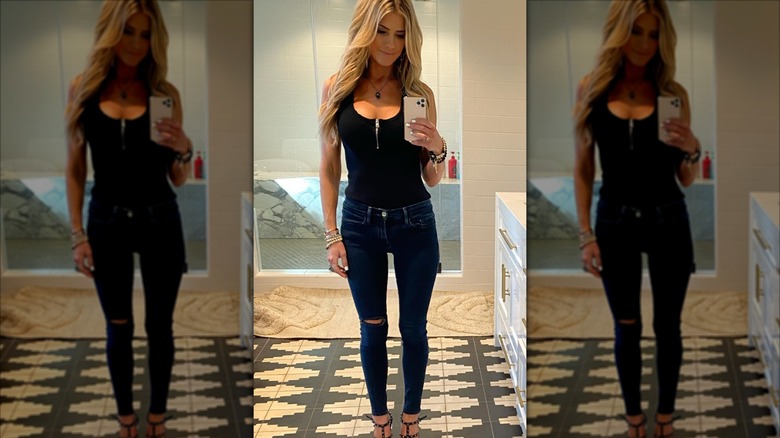 Christina Haack wearing skinny jeans and a black tank top