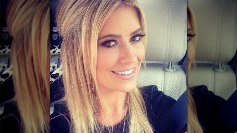 Christina Haack posing in a selfie with dark eye makeup and straight, blonde hair