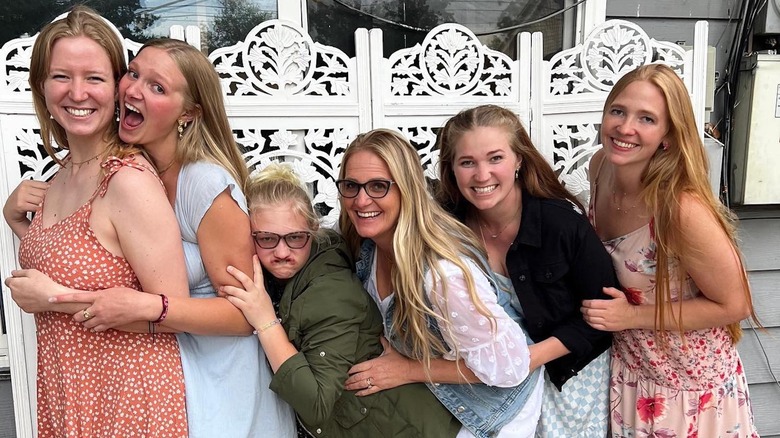 Christine Brown laughing and posing with her daughters