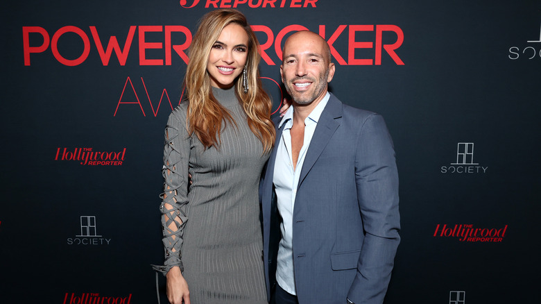 Chrishell Stause and Jason Oppenheim smiling at Power Broker Awards 