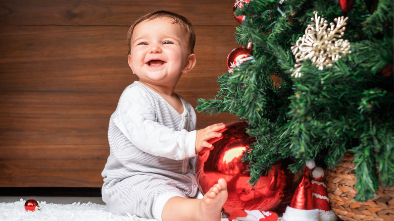 Baby near Christmas tree