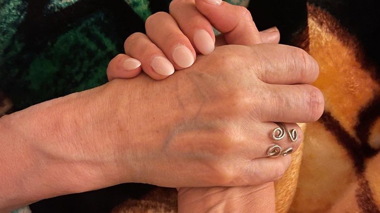 Clare Crawley appears to hold her mom's hand