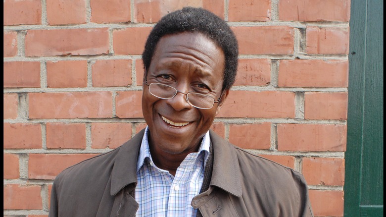 Clarke Peters standing against a brick wall