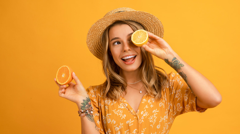 woman in lemon dress holding lemons