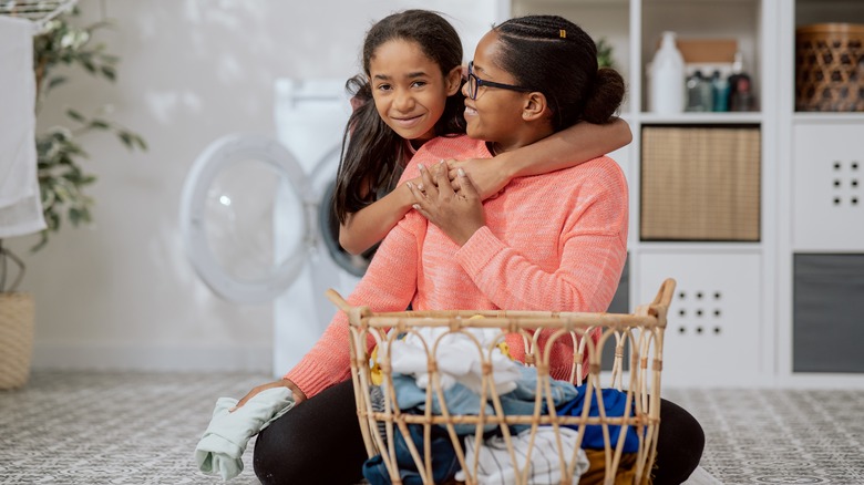 mother and daughter sort laundry